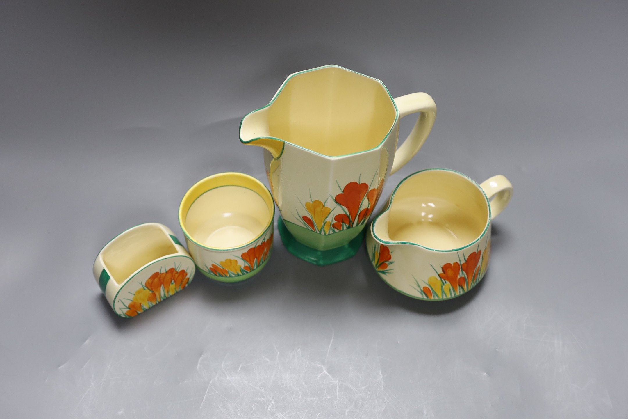 Two Clarice cliff “Sungleam”, crocus jugs and two pots, (4), tallest jug 17 cms high